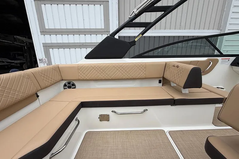 Slide: The Image of 2026 Sea Ray SDX 270 Outboard boat interior with tan seating and modern design. - 11