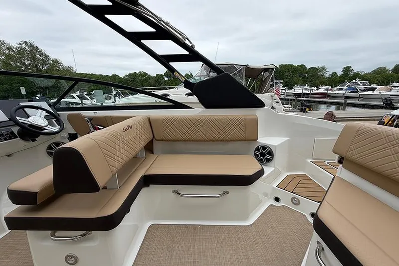 Slide: The Image of 2026 Sea Ray SDX 270 Outboard interior with tan seating and modern design. - 12