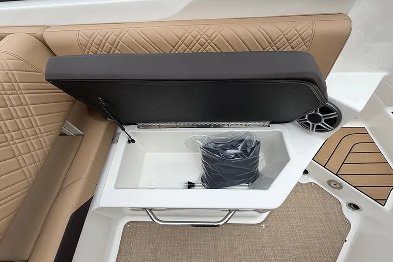 Slide: The Image of 2026 Sea Ray SDX 270 Outboard boat seat storage with beige upholstery and speaker. - 15