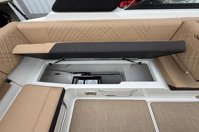 Slide: The Image of 2026 Sea Ray SDX 270 Outboard boat with open storage compartment and beige seating. - 16