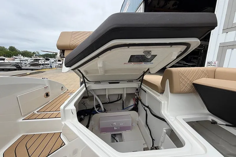 Slide: The Image of Open storage compartment on 2026 Sea Ray SDX 270 Outboard boat, showcasing interior details. - 17