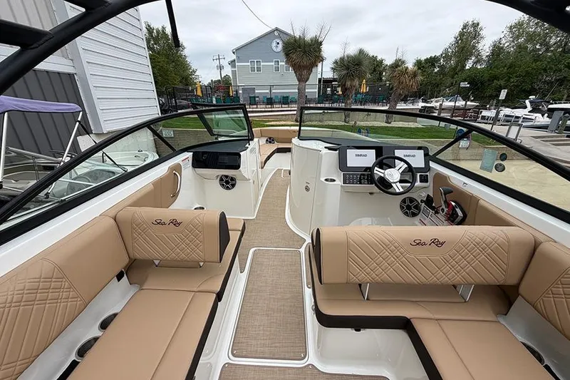 Slide: The Image of 2026 Sea Ray SDX 270 Outboard boat interior with tan seating and modern dashboard. - 18