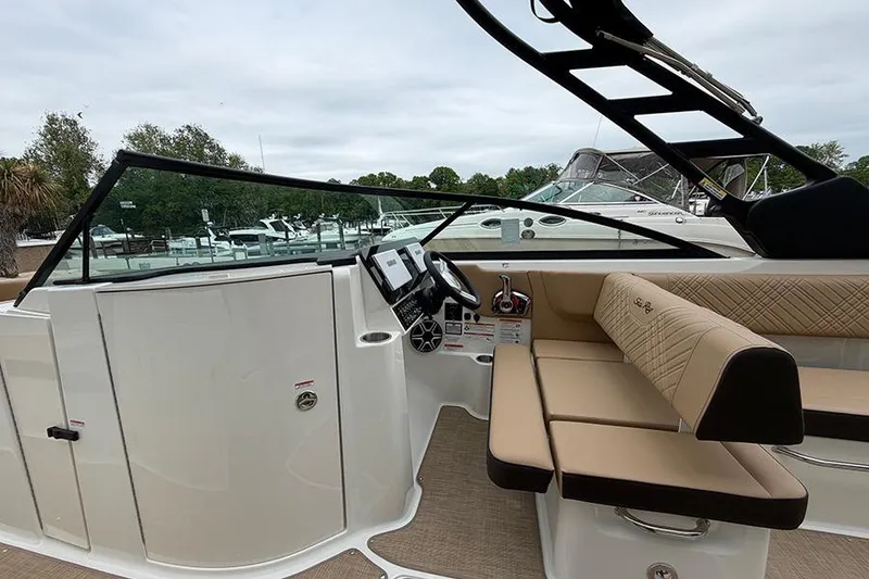 Slide: The Image of 2026 Sea Ray SDX 270 Outboard boat interior with helm and seating area. - 21