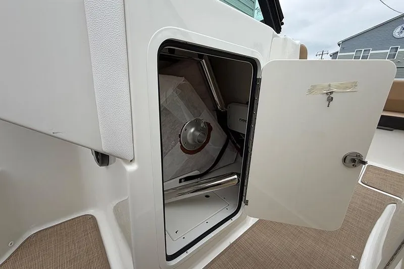 Slide: The Image of Open storage compartment on 2026 Sea Ray SDX 270 Outboard boat. - 27