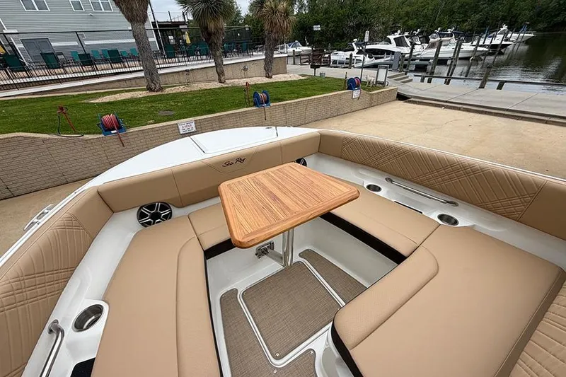 Slide: The Image of Luxurious seating area on 2026 Sea Ray SDX 270 Outboard boat with wooden table. - 32