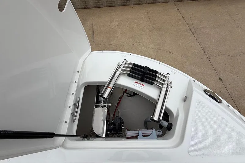 Slide: The Image of 2026 Sea Ray SDX 270 Outboard anchor storage compartment with stainless steel hardware. - 34