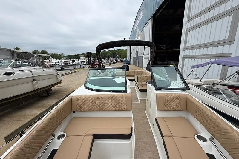 Slide: The Image of 2026 Sea Ray SDX 270 Outboard boat with tan seating at a marina. - 35