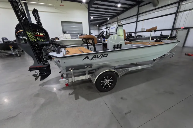 The Image of 2025 Avid 18 Rogue CC boat on trailer in showroom. - 1