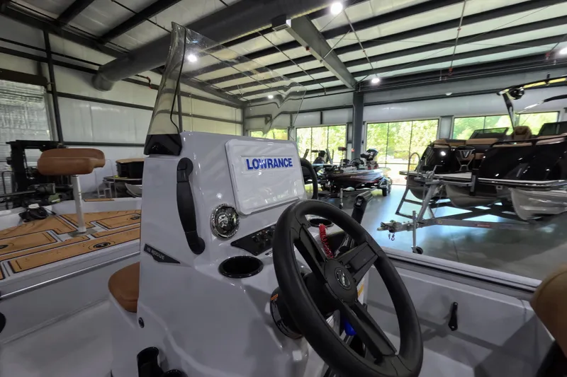 Slide: The Image of Interior view of 2025 Avid 18 Rogue CC boat with steering wheel and Lowrance display. - 4