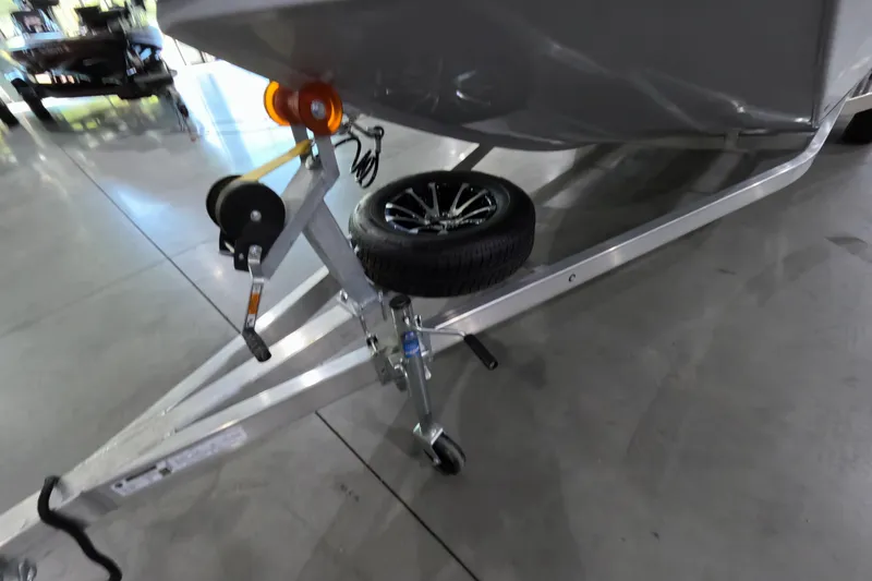 Slide: The Image of Trailer of 2025 Avid 18 Rogue CC boat with spare tire and winch. - 6