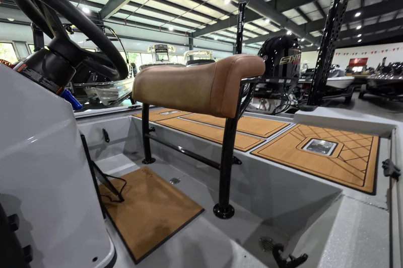 Slide: The Image of Interior of 2025 Avid 18 Rogue CC boat with seating and steering wheel. - 7