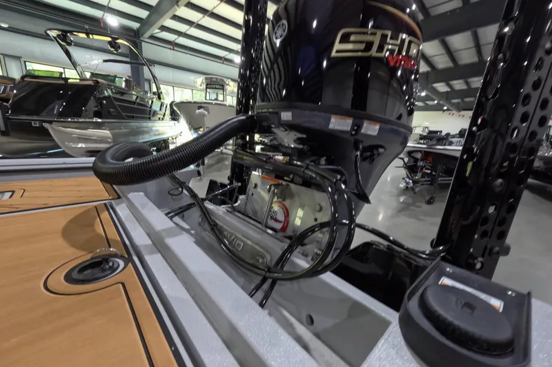 Slide: The Image of 2025 Avid 18 Rogue CC boat engine in showroom, featuring sleek design and advanced technology. - 8