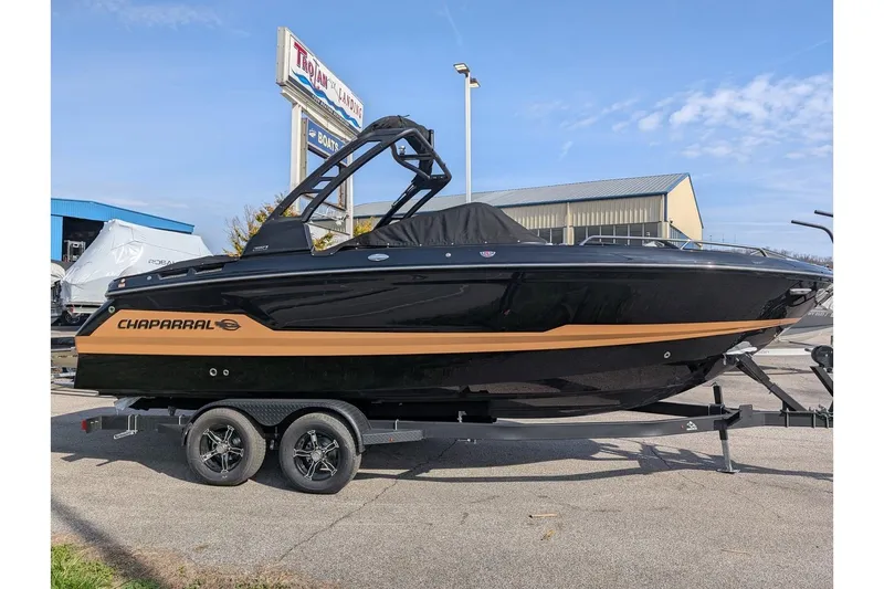 The Image of 2026 Chaparral SSX 6 boat on trailer, black and gold design, outdoor display. - 0