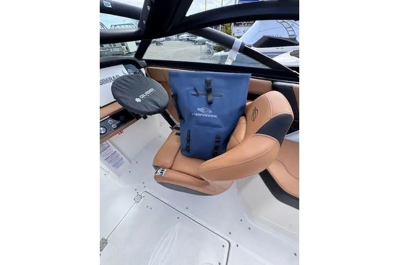 Slide: The Image of 2026 Chaparral SSX 6 boat interior with tan seats and blue Chaparral bag. - 10