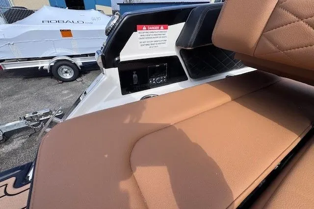 Slide: The Image of 2026 Chaparral SSX 6 boat interior with tan seating and control panel. - 13