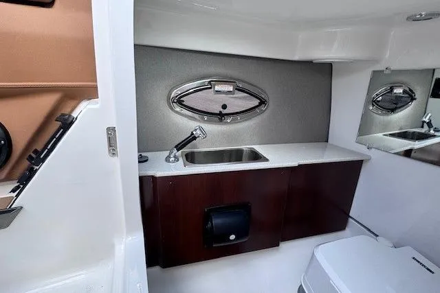 Slide: The Image of Interior of 2026 Chaparral SSX 6 boat featuring a sleek bathroom with sink and mirror. - 16