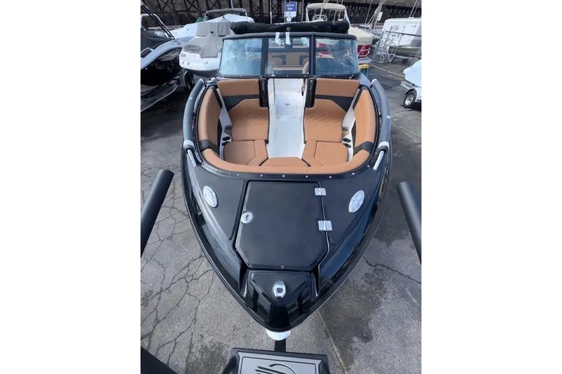 Slide: The Image of 2026 Chaparral SSX 6 boat with sleek black exterior and tan interior seating. - 3