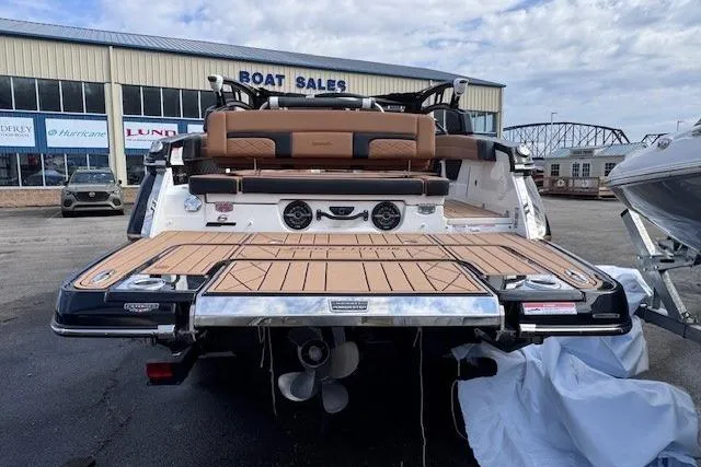 Slide: The Image of 2026 Chaparral SSX 6 boat at dealership, showcasing rear deck and seating. - 4