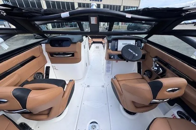 Slide: The Image of Interior view of 2026 Chaparral SSX 6 boat with tan leather seating and modern dashboard. - 6