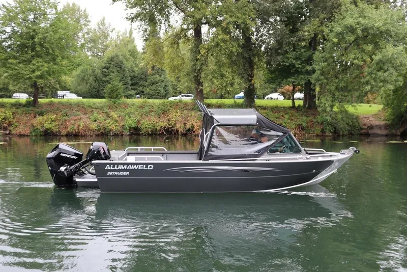 The Image of 2026 Alumaweld Intruder 22 boat cruising on a serene river with lush greenery. - 0