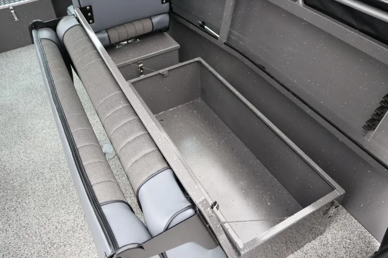 Slide: The Image of 2026 Alumaweld Intruder 22 boat interior with open storage compartment and cushioned seating. - 10