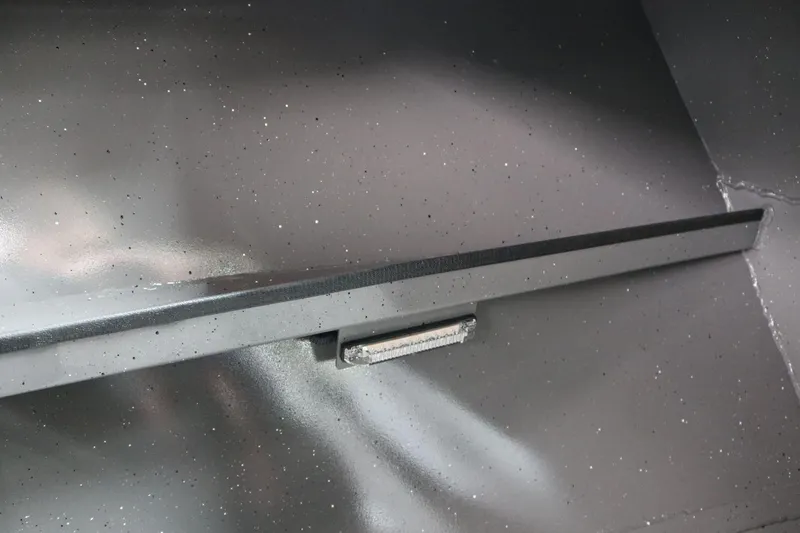 Slide: The Image of Interior detail of 2026 Alumaweld Intruder 22 boat, showcasing sleek metallic finish. - 14