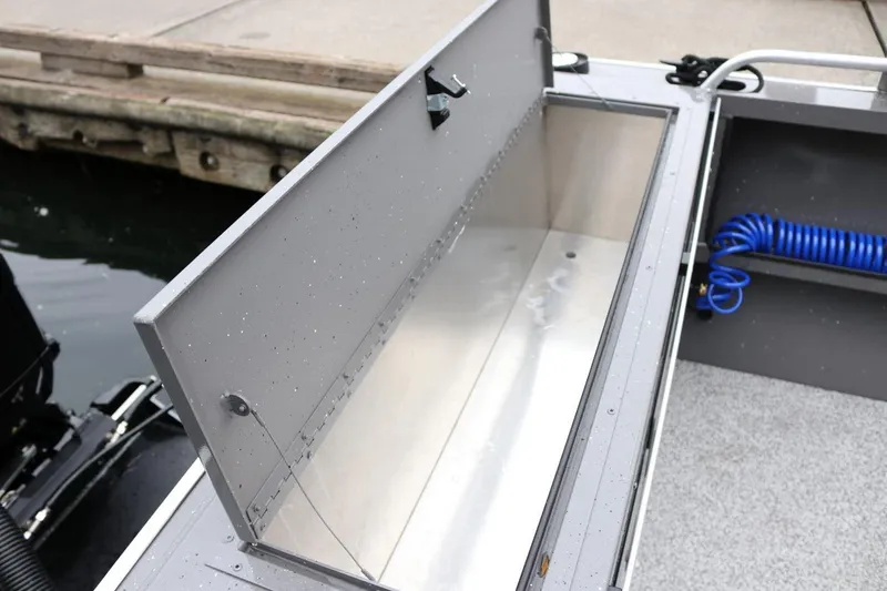 Slide: The Image of Open storage compartment on 2026 Alumaweld Intruder 22 boat, dockside view. - 17