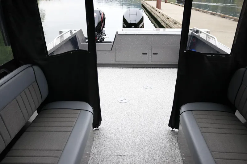 Slide: The Image of Interior view of 2026 Alumaweld Intruder 22 boat with seating and outboard motor. - 19