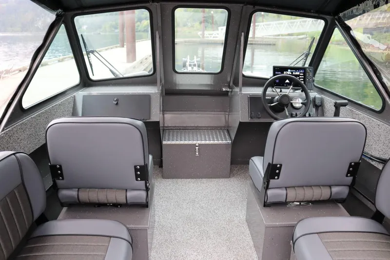 Slide: The Image of Interior of 2026 Alumaweld Intruder 22 boat with modern seating and steering console. - 2
