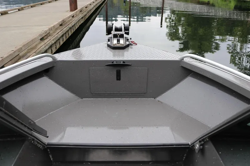 Slide: The Image of 2026 Alumaweld Intruder 22 boat bow, docked on calm water. - 21