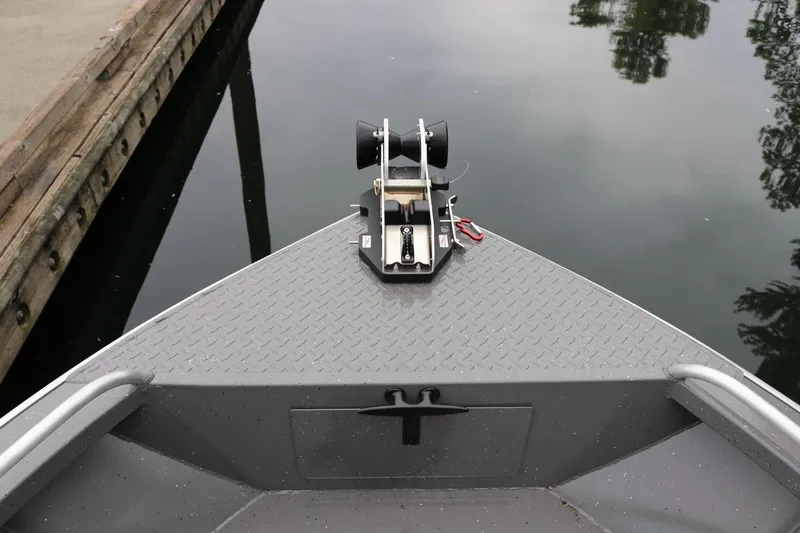 Slide: The Image of Bow of 2026 Alumaweld Intruder 22 boat with anchor system, dockside view. - 22