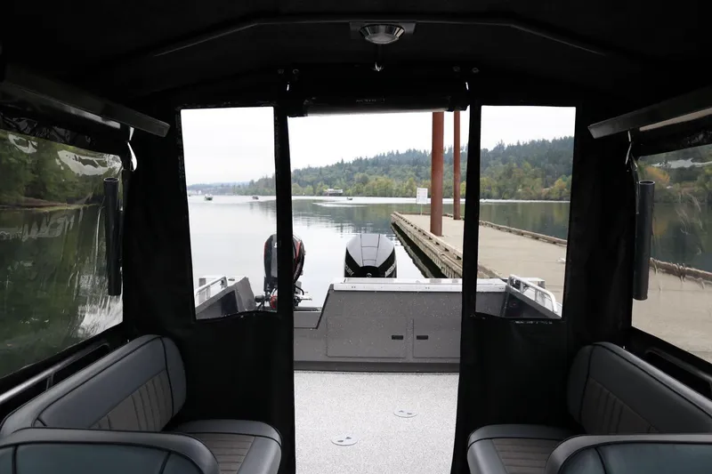 Slide: The Image of Interior view of 2026 Alumaweld Intruder 22 boat docked by a serene lake. - 25
