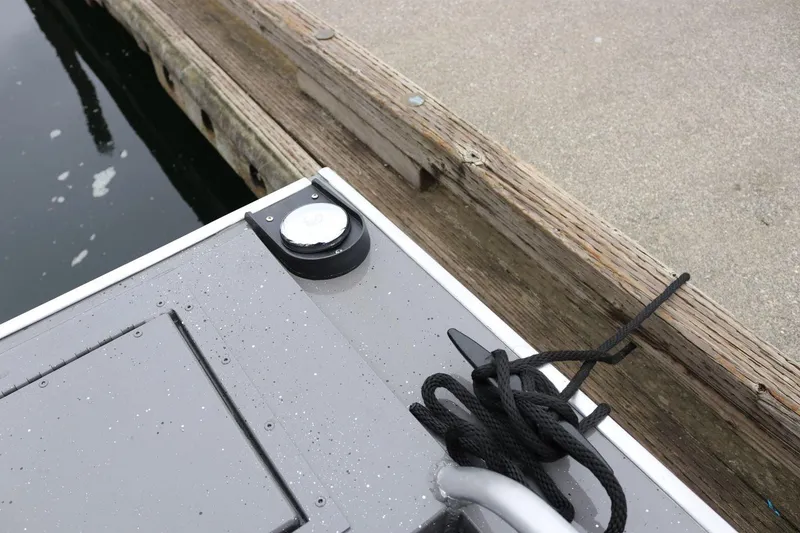 Slide: The Image of 2026 Alumaweld Intruder 22 boat docked, showing cleat and rope detail. - 26
