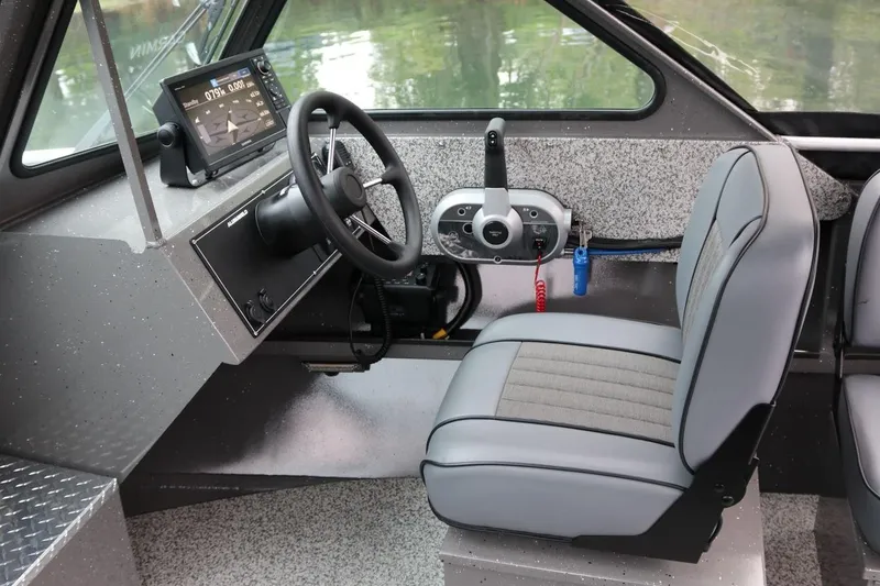 Slide: The Image of 2026 Alumaweld Intruder 22 boat interior with steering wheel and control panel. - 4