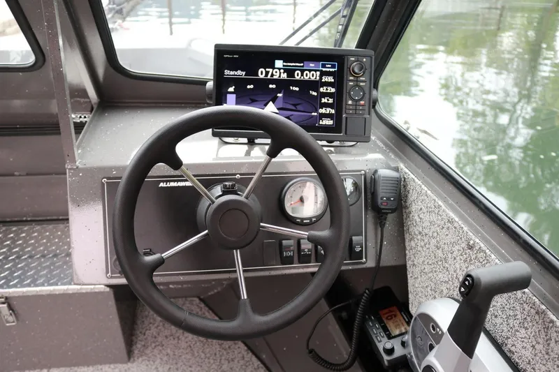 Slide: The Image of 2026 Alumaweld Intruder 22 boat dashboard with steering wheel and navigation display. - 5