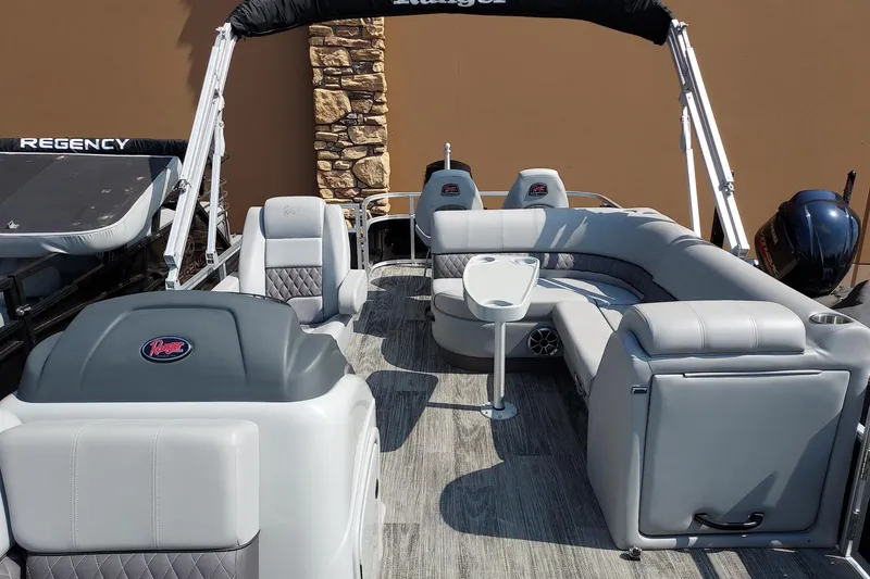 Slide: The Image of 2024 Ranger Reata 220FC pontoon boat with luxurious seating and modern design. - 4