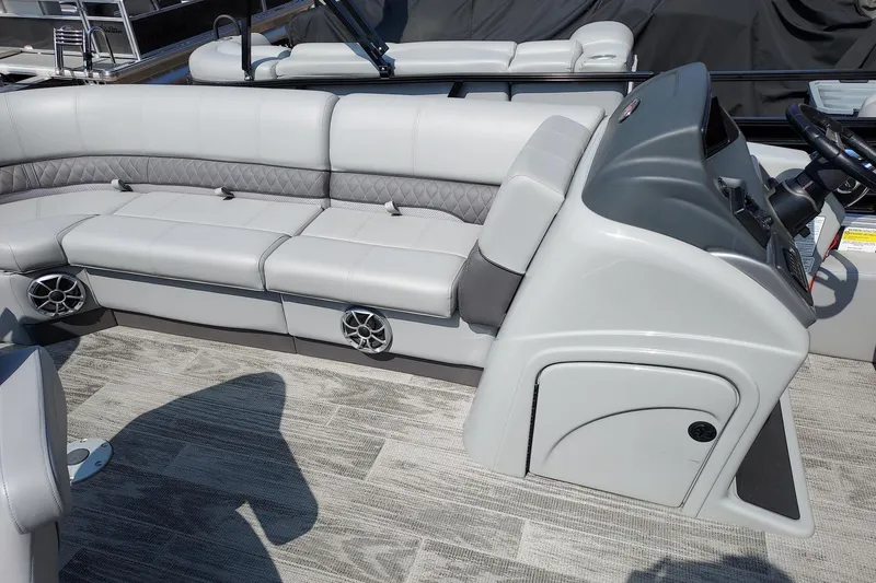 Slide: The Image of 2024 Ranger Reata 220FC boat interior with gray seating and modern dashboard design. - 6