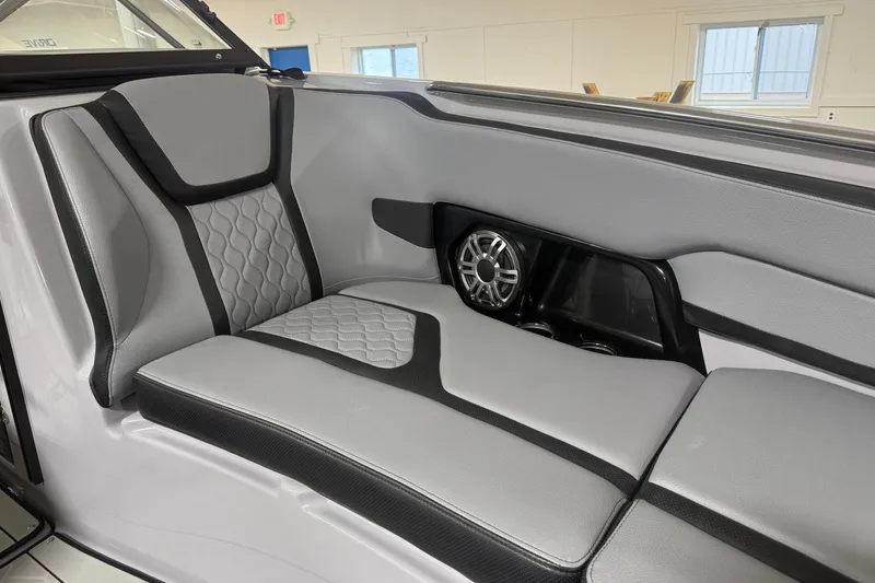 Slide: The Image of 2026 Yamaha Boats 255XD interior seating with sleek design and integrated speaker system. - 11