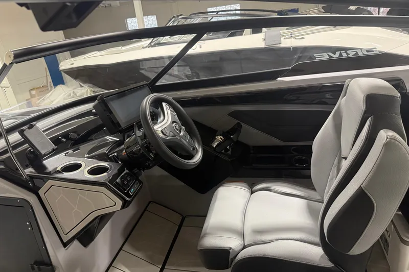 Slide: The Image of Interior of 2026 Yamaha Boats 255XD, featuring modern steering and control panel. - 4