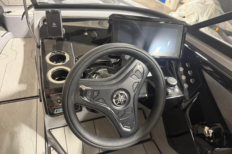 Slide: The Image of 2026 Yamaha Boats 255XD dashboard with steering wheel, touchscreen, and cup holders. - 5