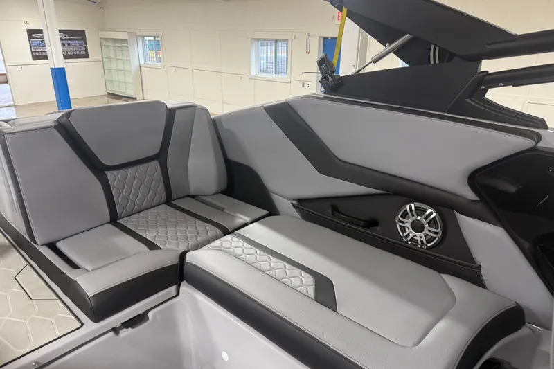 Slide: The Image of 2026 Yamaha Boats 255XD interior with sleek gray seating and built-in speaker. - 7