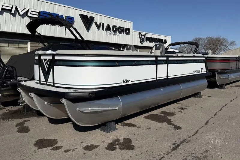 The Image of 2026 Viaggio Lago V22S pontoon boat displayed outdoors at dealership. - 0