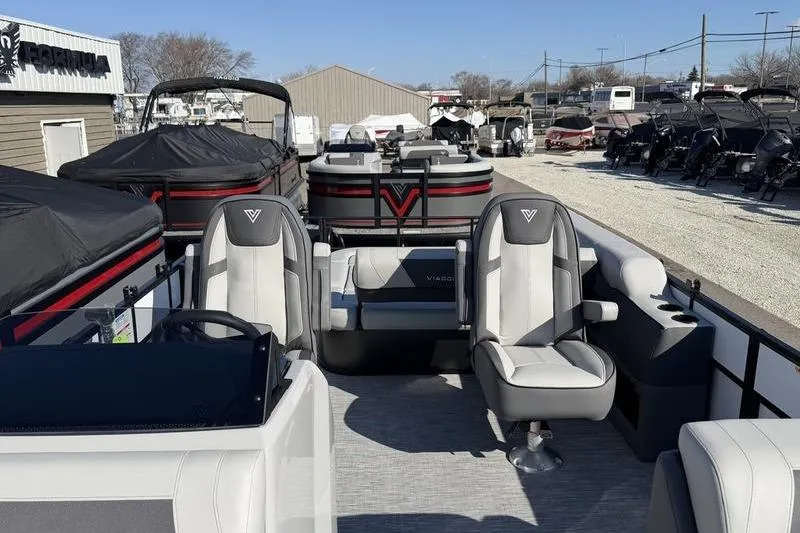 Slide: The Image of 2026 Viaggio Lago V22S pontoon boat with modern seating and sleek design in a showroom. - 5
