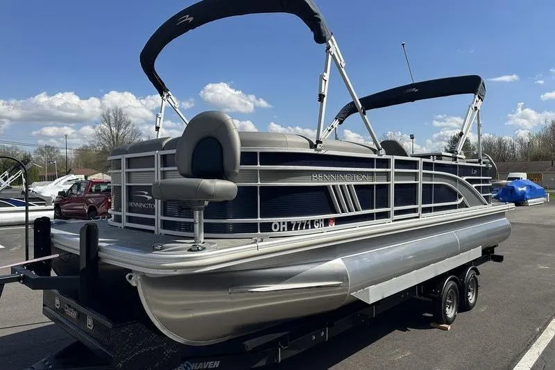 Slide: The Image of 2022 Bennington LPD boat interior with storage compartment and cup holders. - 13