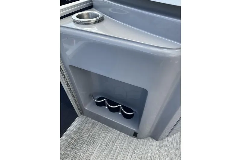 Slide: The Image of 2022 Bennington LPD boat console with cup holders and sleek design. - 14