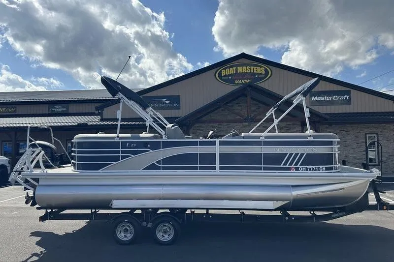 Slide: The Image of 2022 Bennington LPD pontoon boat interior with gray seating and central table. - 16