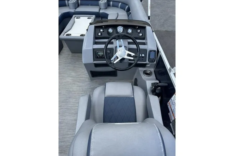 Slide: The Image of 2022 Bennington LPD boat interior with steering wheel and seating area. - 21