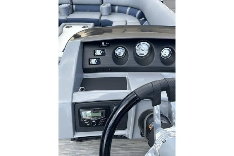 Slide: The Image of 2022 Bennington LPD pontoon boat on trailer under a clear blue sky. - 6