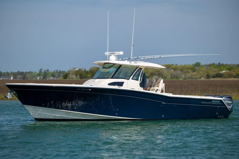 Slide: The Image of 2017 Grady-White Canyon 376 boat on water, side view, clear sky background. - 10
