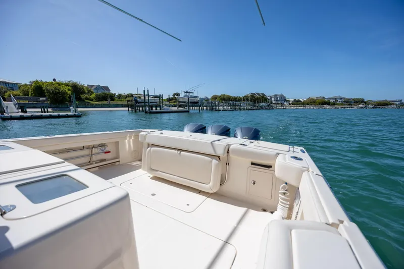 Slide: The Image of 2017 Grady-White Canyon 376 boat on calm waters near a dock. - 15
